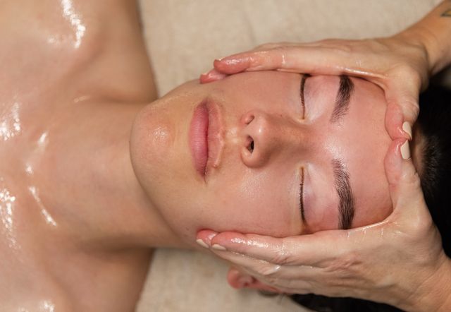 Lymphatic facial massage across the forehead and temples